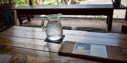 A jug of cold water, with slices of lemon for flavor